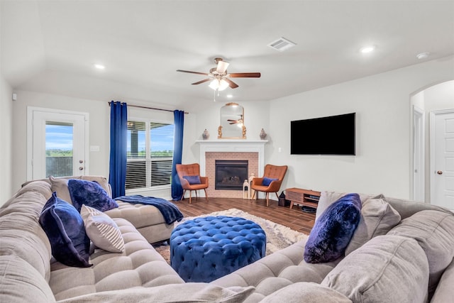 2125 Swanmore Way, Forney, TX 75126 - living area with arched walkways, a ceiling fan, wood finished floors, recessed lighting, and a fireplace
