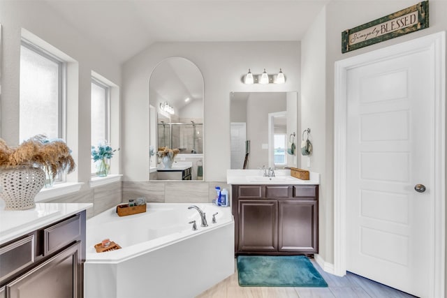 2125 Swanmore Way, Forney, TX 75126 - bathroom with a stall shower, vaulted ceiling, a garden tub, and vanity