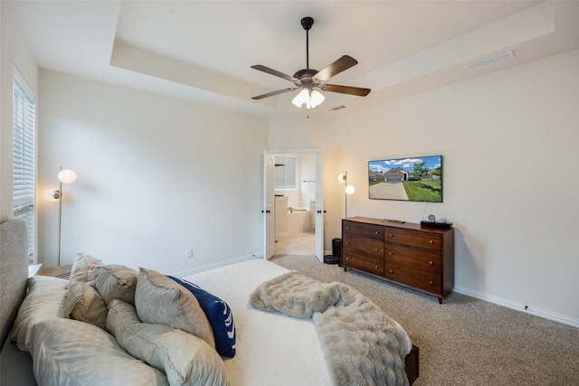 3129 Greymoore Dr, Anna, TX 75409 - bedroom featuring light colored carpet, baseboards, ensuite bath, ceiling fan, and a raised ceiling