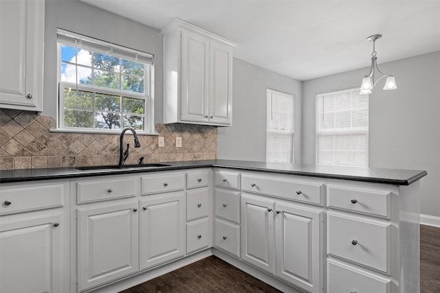 4016 Austin Ave, Waco, TX 76710 - kitchen with a sink, dark countertops, a peninsula, and tasteful backsplash