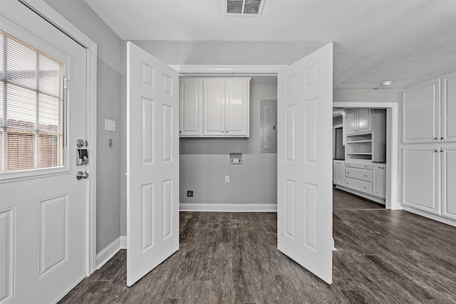 4016 Austin Ave, Waco, TX 76710 - clothes washing area with hookup for a washing machine, cabinet space, dark wood-style flooring, baseboards, and electric panel