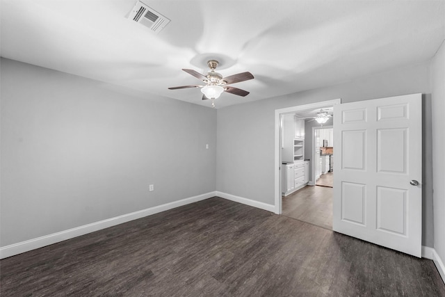 4016 Austin Ave, Waco, TX 76710 - empty room featuring a ceiling fan, dark wood-style floors, and baseboards