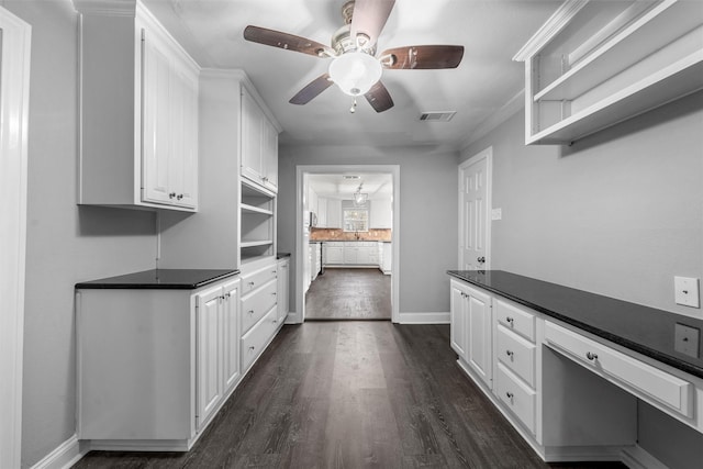 4016 Austin Ave, Waco, TX 76710 - kitchen with open shelves, white cabinetry, dark wood-type flooring, ceiling fan, and dark countertops