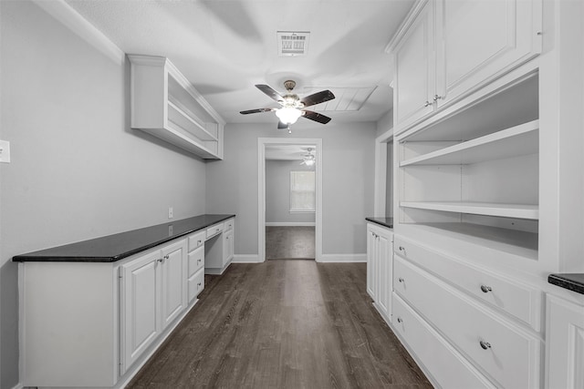 4016 Austin Ave, Waco, TX 76710 - spacious closet with a ceiling fan, dark wood-style floors, and built in study area