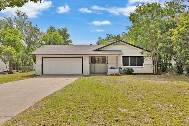 2409 Janice Ln, Fort Worth, TX 76112 - view of front of property with a garage, brick siding, driveway, and a front yard