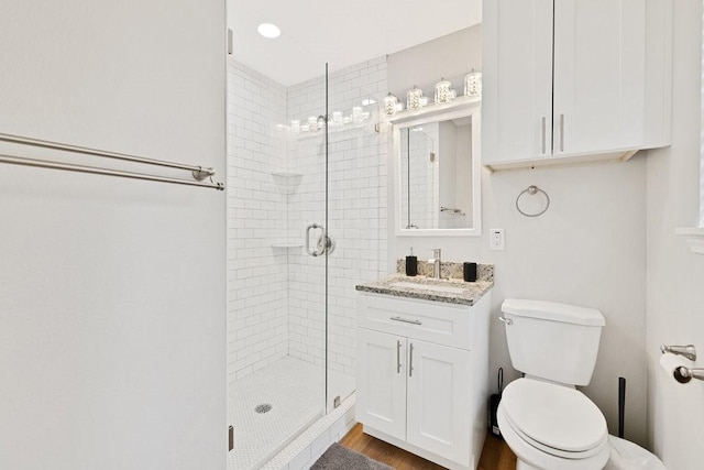 2409 Janice Ln, Fort Worth, TX 76112 - full bathroom featuring a shower stall, toilet, vanity, and wood finished floors