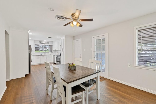 2409 Janice Ln, Fort Worth, TX 76112 - dining area featuring wood finished floors, a ceiling fan, baseboards, and recessed lighting
