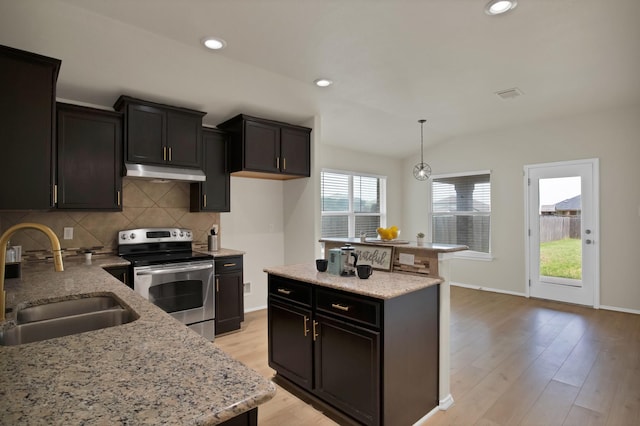 10152 Parker Springs Dr, Waco, TX 76708 - kitchen with stainless steel electric stove, under cabinet range hood, a sink, tasteful backsplash, and lofted ceiling