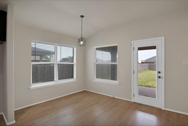10152 Parker Springs Dr, Waco, TX 76708 - unfurnished dining area with wood finished floors, plenty of natural light, a chandelier, lofted ceiling, and baseboards