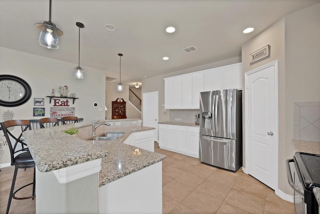 2202 Louis Trl, Weatherford, TX 76087 - kitchen featuring stainless steel refrigerator with ice dispenser, a sink, electric range, a kitchen breakfast bar, and recessed lighting