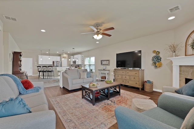 2202 Louis Trl, Weatherford, TX 76087 - living room featuring ceiling fan, wood finished floors, recessed lighting, a tiled fireplace, and baseboards