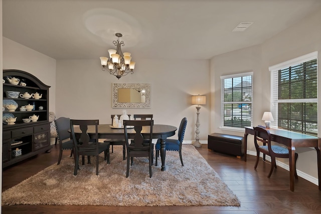 2202 Louis Trl, Weatherford, TX 76087 - dining space with a chandelier, dark wood-style flooring, and baseboards