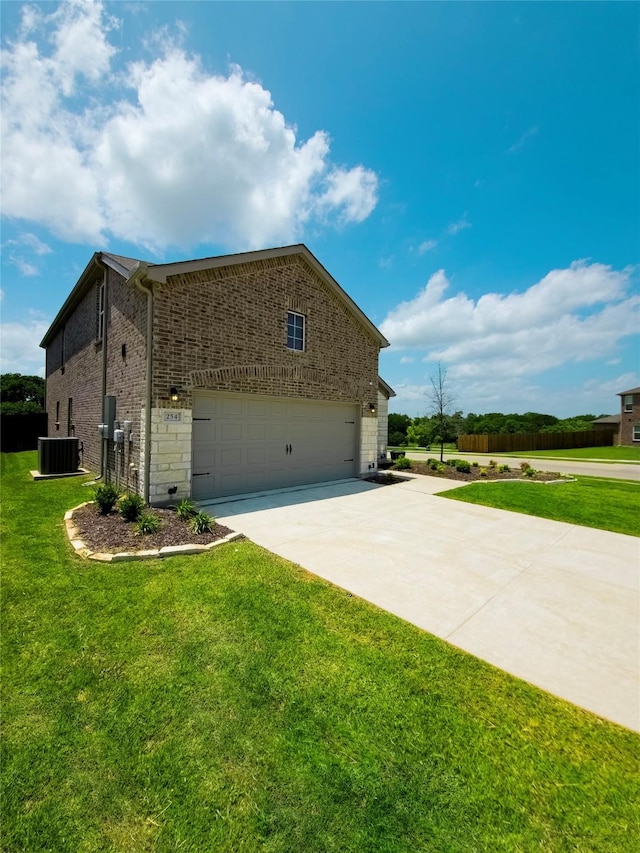 254 Lake Erie Dr, Princeton, TX 75407 - view of property exterior featuring concrete driveway, a garage, brick siding, a lawn, and central AC