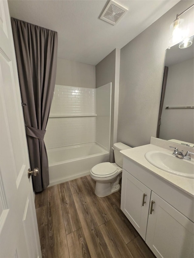 254 Lake Erie Dr, Princeton, TX 75407 - full bathroom featuring vanity, wood finished floors, shower / bathtub combination, and toilet
