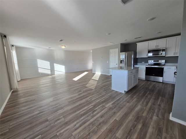 254 Lake Erie Dr, Princeton, TX 75407 - kitchen with appliances with stainless steel finishes, open floor plan, dark wood-type flooring, and a kitchen island