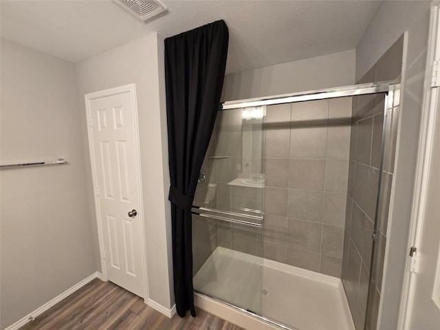 254 Lake Erie Dr, Princeton, TX 75407 - full bath featuring wood finished floors, a shower stall, and baseboards