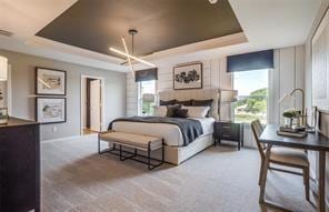 254 Lake Erie Dr, Princeton, TX 75407 - bedroom with a raised ceiling, multiple windows, carpet floors, and baseboards