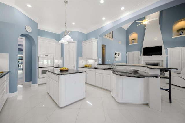2410 Gail St, Royse City, TX 75189 - kitchen featuring white appliances, dark countertops, arched walkways, ornamental molding, and ceiling fan