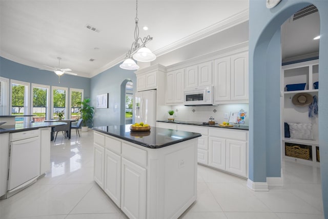 2410 Gail St, Royse City, TX 75189 - kitchen with arched walkways, white appliances, dark countertops, ornamental molding, and white cabinets