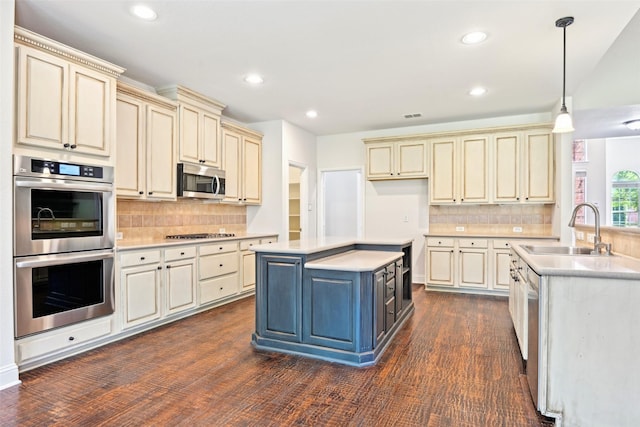 8604 Preston Wood Dr, Mckinney, TX 75072 - kitchen featuring cream cabinets, appliances with stainless steel finishes, a sink, light countertops, and recessed lighting