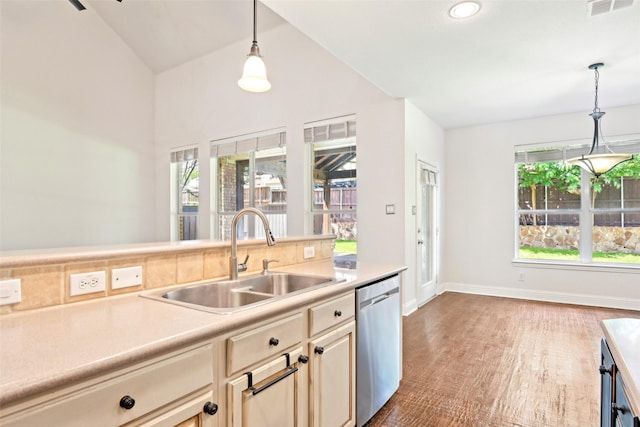 8604 Preston Wood Dr, Mckinney, TX 75072 - kitchen with stainless steel dishwasher, a sink, light countertops, decorative light fixtures, and lofted ceiling
