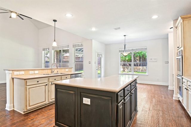 8604 Preston Wood Dr, Mckinney, TX 75072 - kitchen with a sink, an island with sink, cream cabinetry, light countertops, and recessed lighting