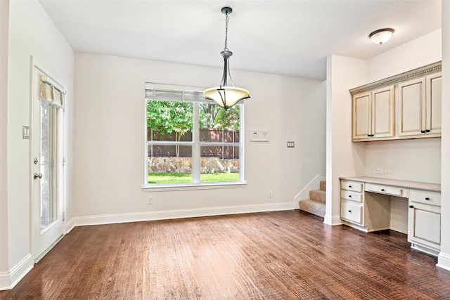 8604 Preston Wood Dr, Mckinney, TX 75072 - unfurnished dining area with dark wood-style floors, stairs, and baseboards