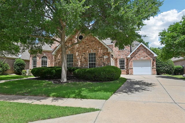 8604 Preston Wood Dr, Mckinney, TX 75072 - view of front of home featuring driveway, a front yard, brick siding, and a garage