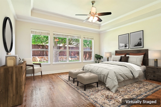 8604 Preston Wood Dr, Mckinney, TX 75072 - bedroom featuring a raised ceiling, crown molding, wood finished floors, baseboards, and ceiling fan