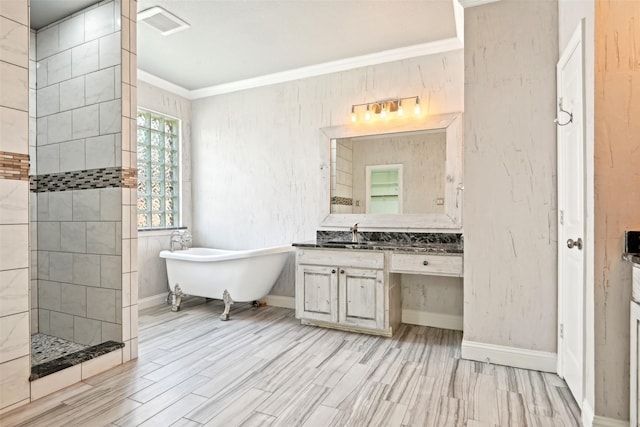 8604 Preston Wood Dr, Mckinney, TX 75072 - bathroom with ornamental molding, a walk in shower, a freestanding bath, vanity, and wood finished floors