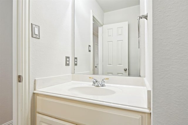8604 Preston Wood Dr, Mckinney, TX 75072 - bathroom with a textured wall and vanity