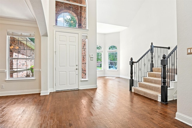 8604 Preston Wood Dr, Mckinney, TX 75072 - foyer entrance with wood finished floors, stairway, a high ceiling, and baseboards