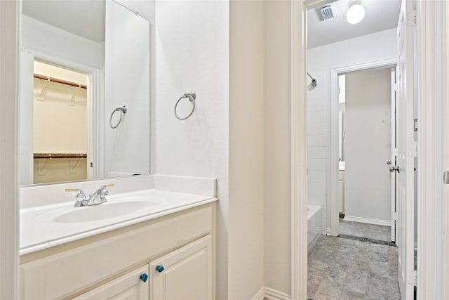 8604 Preston Wood Dr, Mckinney, TX 75072 - full bath featuring a spacious closet, vanity, baseboards, and washtub / shower combination
