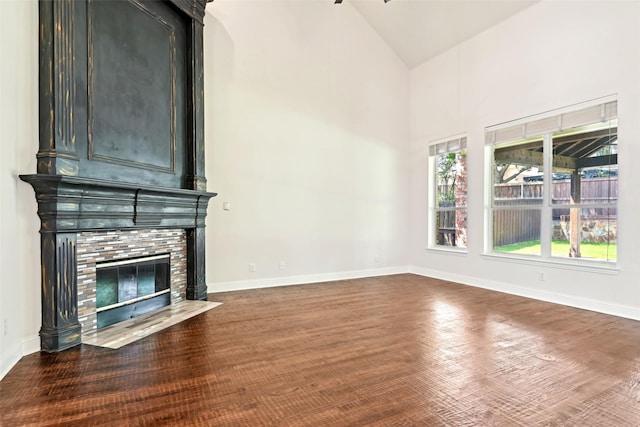 8604 Preston Wood Dr, Mckinney, TX 75072 - unfurnished living room featuring a fireplace, baseboards, high vaulted ceiling, and wood finished floors