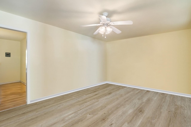 1128 Redbud St, Denison, TX 75020 - unfurnished room with light wood-type flooring, baseboards, and a ceiling fan