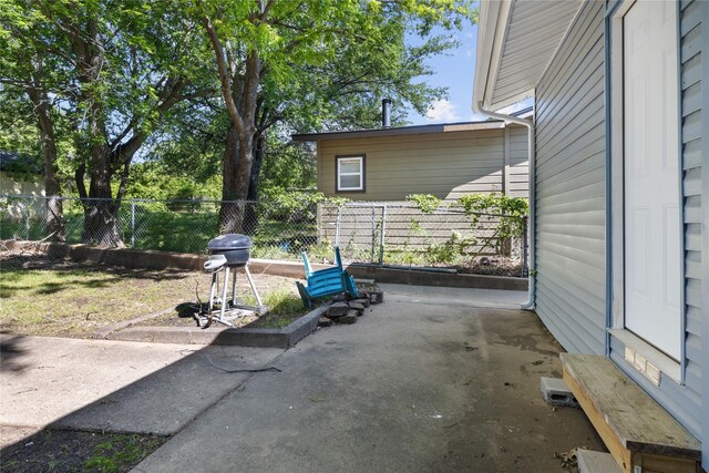1128 Redbud St, Denison, TX 75020 - view of patio featuring fence and a grill