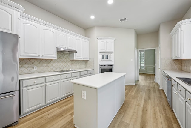 1612 University Dr, Allen, TX 75013 - kitchen with appliances with stainless steel finishes, recessed lighting, under cabinet range hood, light wood-style flooring, and tasteful backsplash