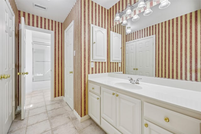 1612 University Dr, Allen, TX 75013 - bathroom featuring vanity, tile patterned flooring, wallpapered walls, and baseboards