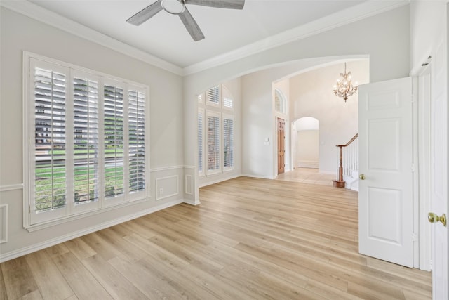 1612 University Dr, Allen, TX 75013 - unfurnished room with arched walkways, light wood-type flooring, crown molding, ceiling fan, and stairway