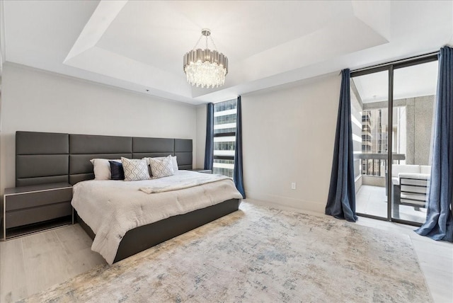 5909 Luther Ln Unit 1002, Dallas, TX 75225 - bedroom featuring access to outside, a chandelier, a raised ceiling, and baseboards