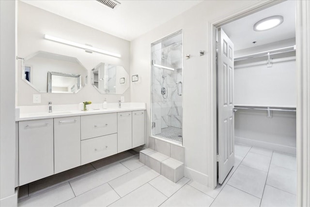 5909 Luther Ln Unit 1002, Dallas, TX 75225 - full bath with a marble finish shower, a walk in closet, tile patterned floors, double vanity, and baseboards
