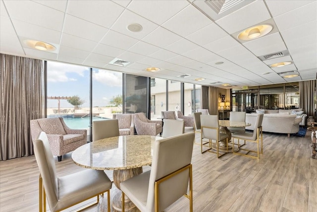 5909 Luther Ln Unit 1002, Dallas, TX 75225 - dining space featuring light wood-type flooring and floor to ceiling windows