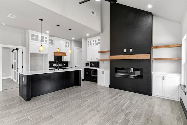 2519 Lakeridge Dr, Granbury, TX 76048 - kitchen featuring light countertops, light wood-type flooring, white cabinets, open shelves, and recessed lighting