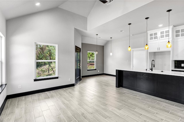 2519 Lakeridge Dr, Granbury, TX 76048 - kitchen with a sink, light countertops, glass insert cabinets, recessed lighting, and high vaulted ceiling
