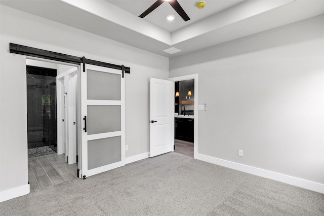 2519 Lakeridge Dr, Granbury, TX 76048 - unfurnished bedroom featuring carpet floors, baseboards, a sink, a barn door, and recessed lighting