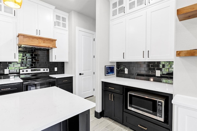2519 Lakeridge Dr, Granbury, TX 76048 - kitchen featuring stainless steel appliances, white cabinets, light countertops, and recessed lighting
