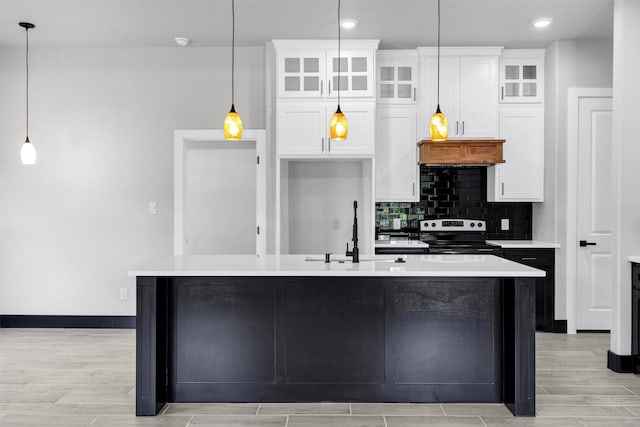 2519 Lakeridge Dr, Granbury, TX 76048 - kitchen featuring stainless steel range with electric stovetop, a sink, white cabinets, and recessed lighting