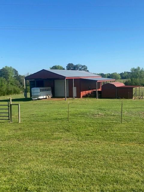 6888 Fm 2888, Naples, TX 75568 - back of property featuring an outbuilding, an outdoor structure, and a detached garage