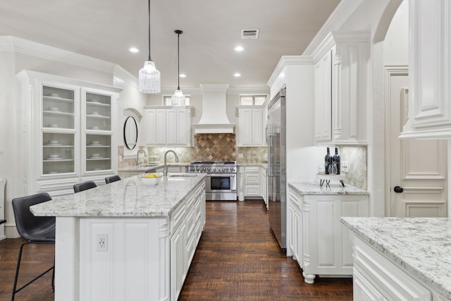 54 Cypress Ct, Trophy Club, TX 76262 - kitchen featuring high end appliances, a sink, custom range hood, white cabinetry, and a center island with sink