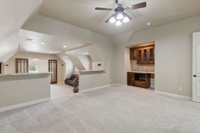 54 Cypress Ct, Trophy Club, TX 76262 - unfurnished living room with lofted ceiling, light carpet, ceiling fan, baseboards, and a dry bar